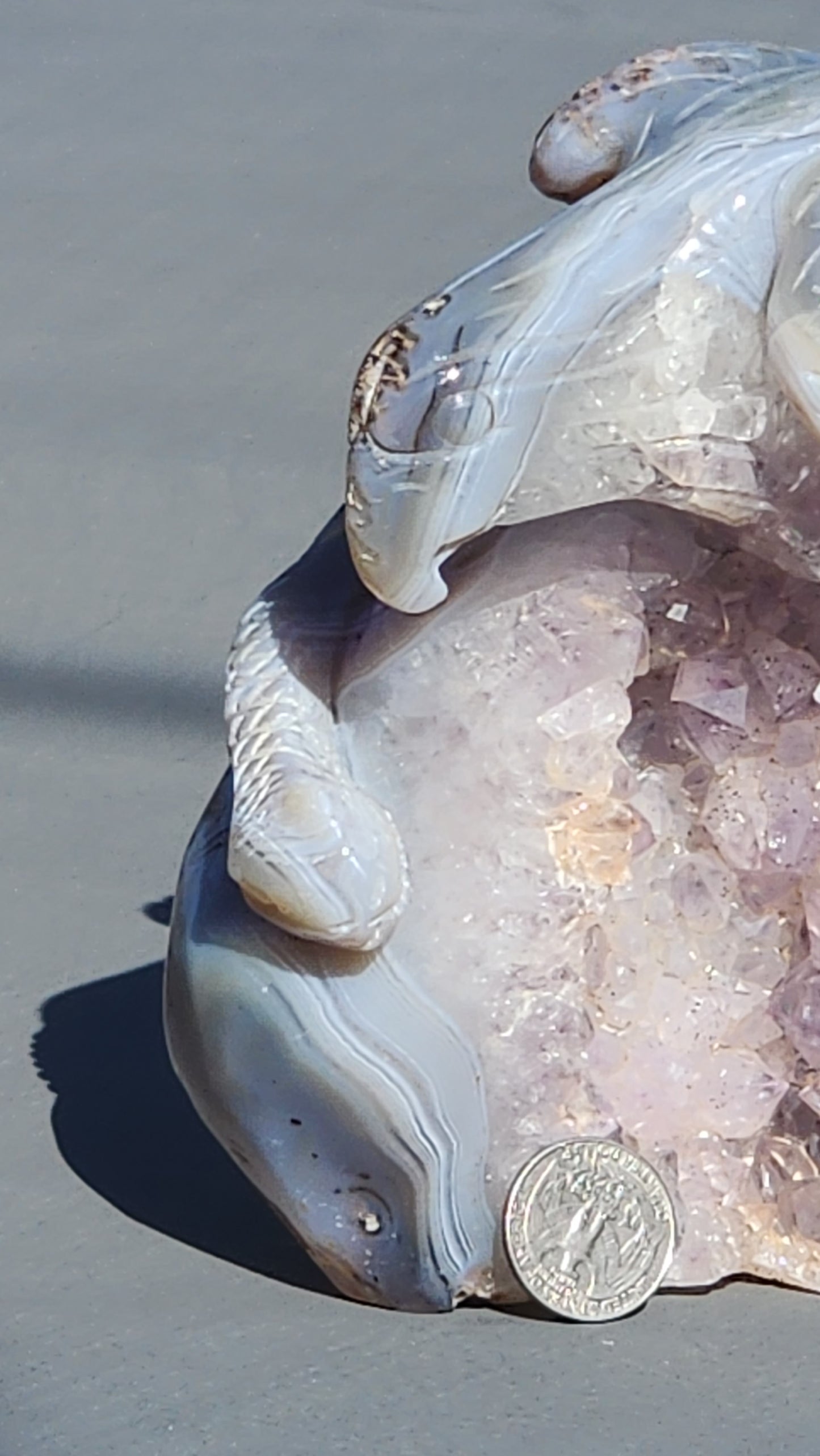 Hand carved eagle with snake on amethyst cluster