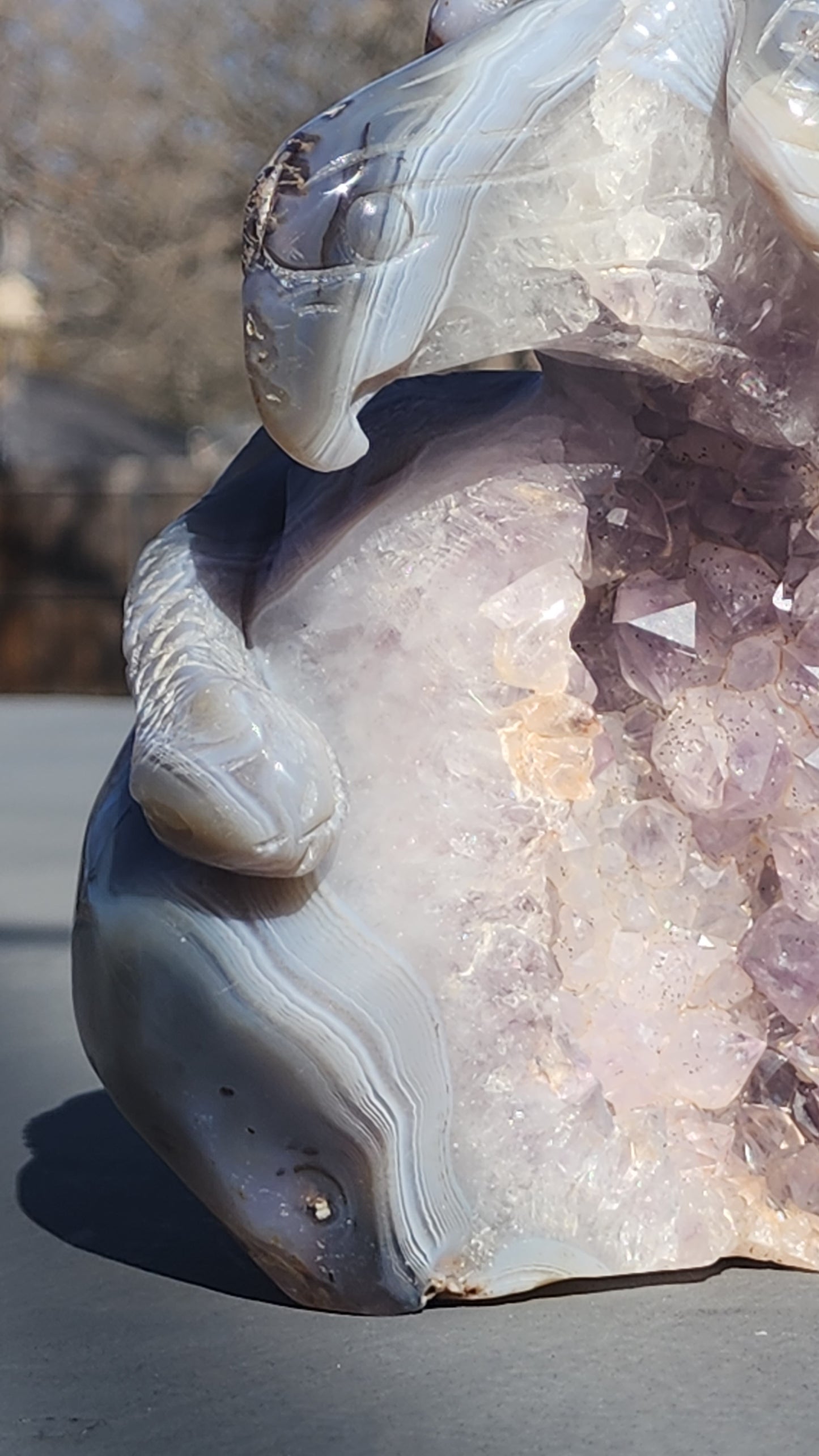Hand carved eagle with snake on amethyst cluster
