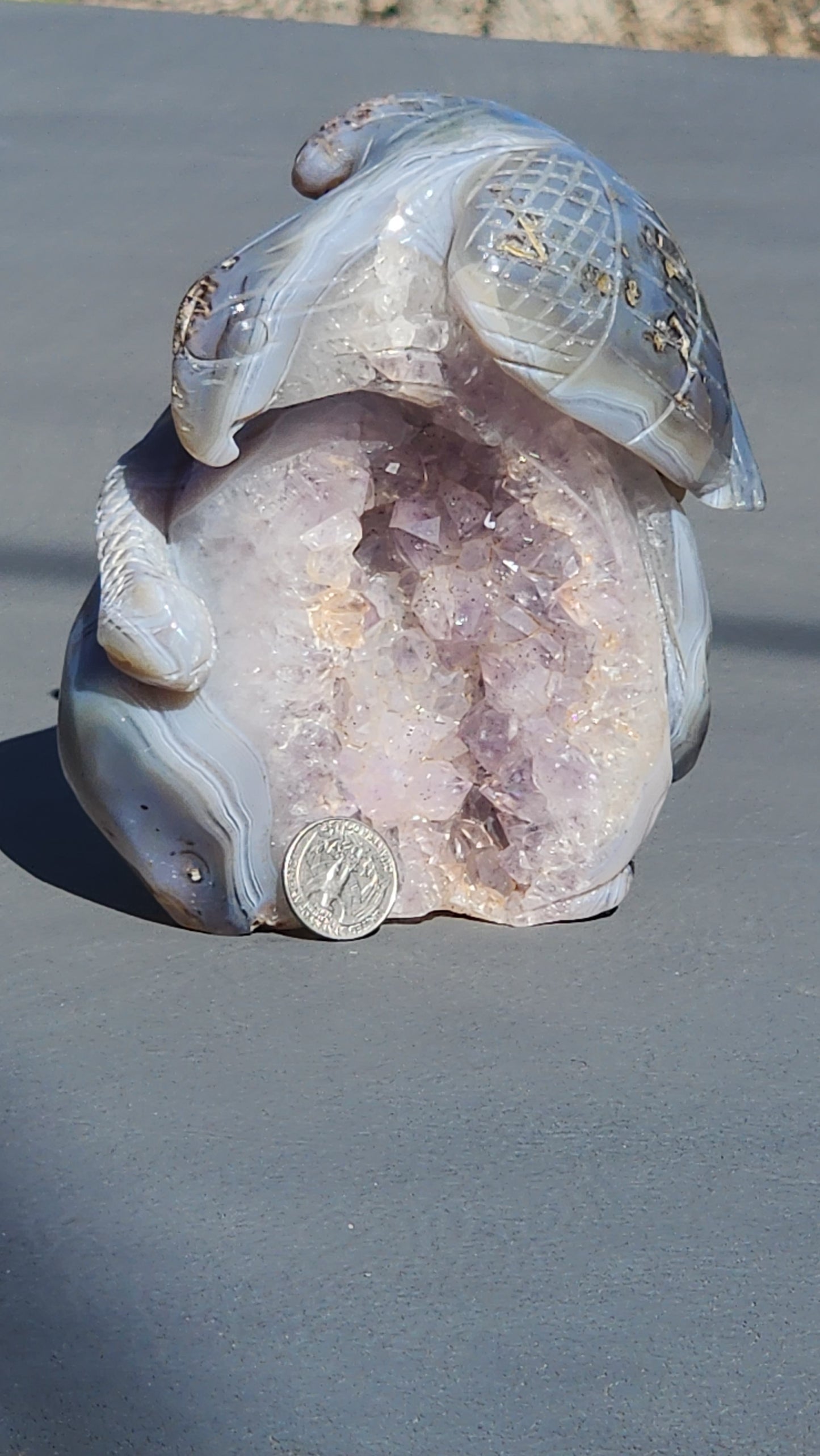 Hand carved eagle with snake on amethyst cluster