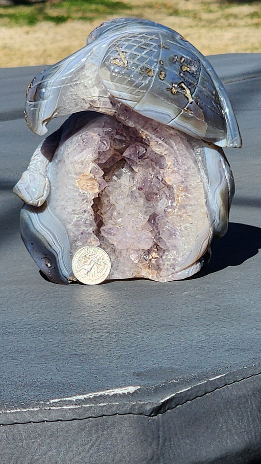 Hand carved eagle with snake on amethyst cluster